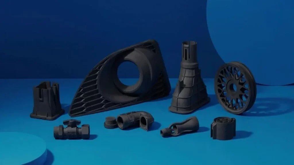 An assortment of black 3D printed components and parts displayed on a blue background.