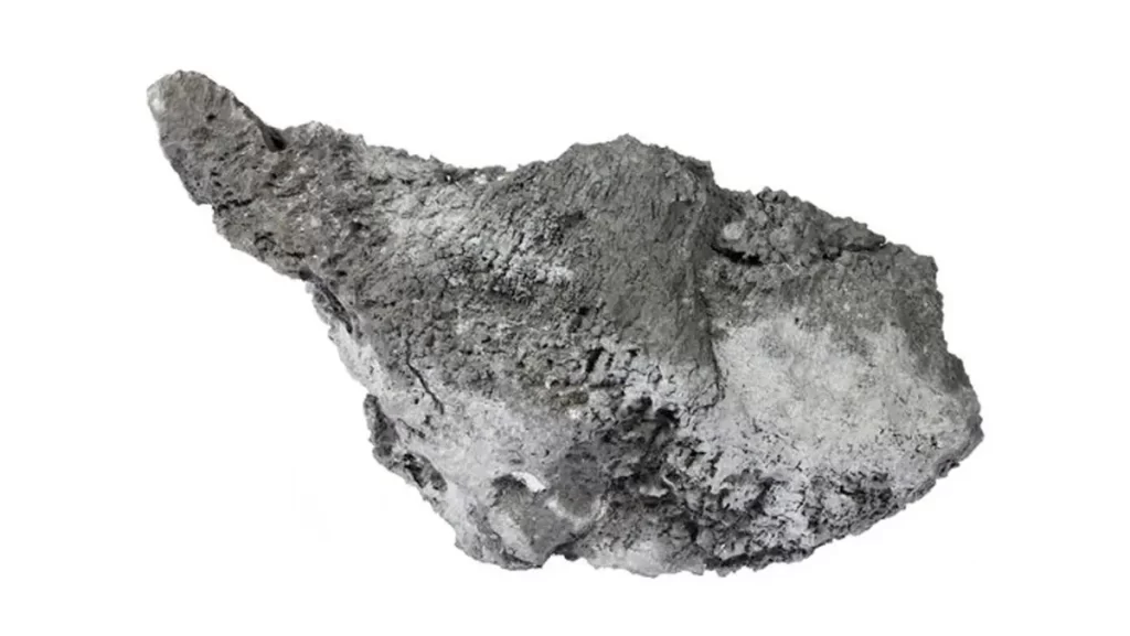 A piece of the element arsenic, appearing gray and somewhat porous.