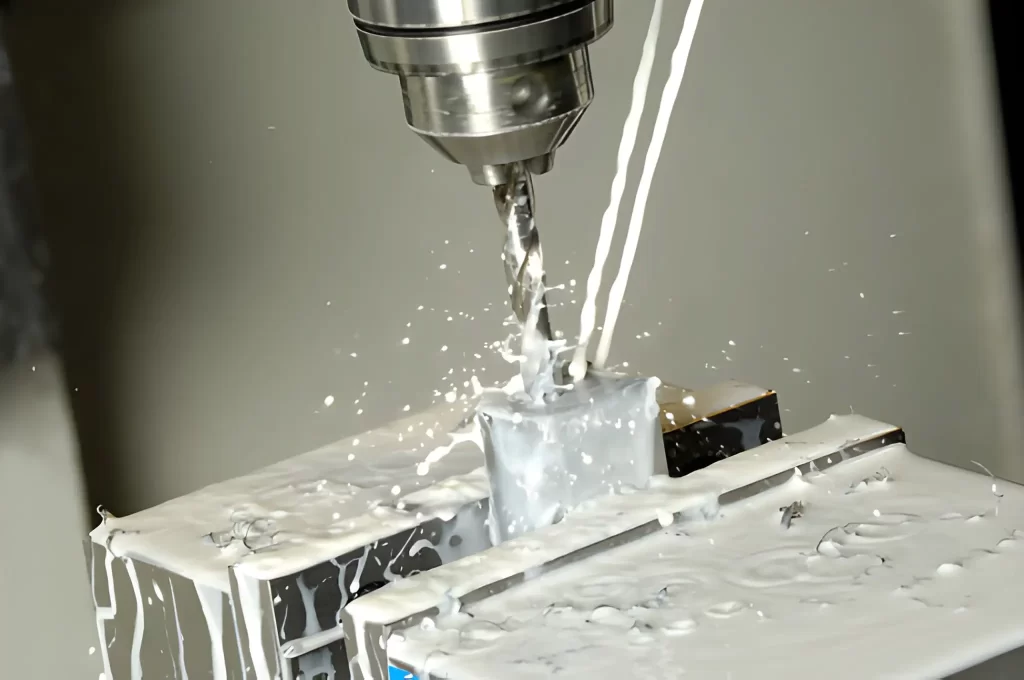 CNC drilling operation in progress with coolant fluid spraying over the drill bit and workpiece