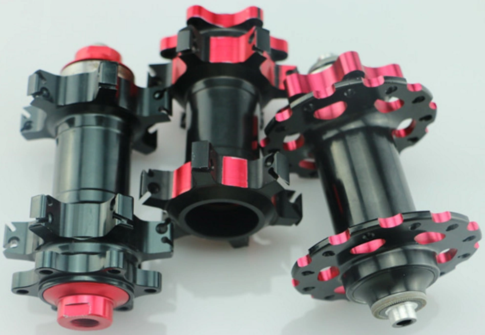 Three CNC-machined black and pink prototype parts for a bike