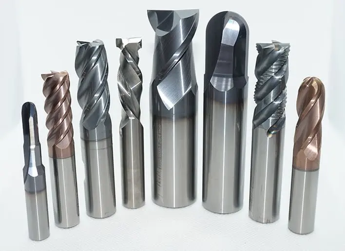 Set of various end mill cutters in different sizes and shapes, designed for CNC machining and precision metal cutting applications.