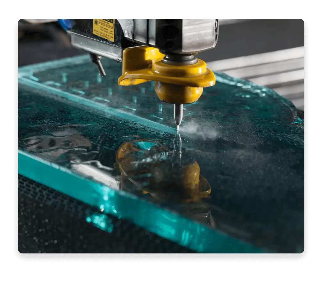 Close-up of a water jet cutter slicing through metal with precision.