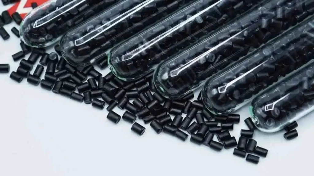 Glass test tubes filled with black plastic pellets