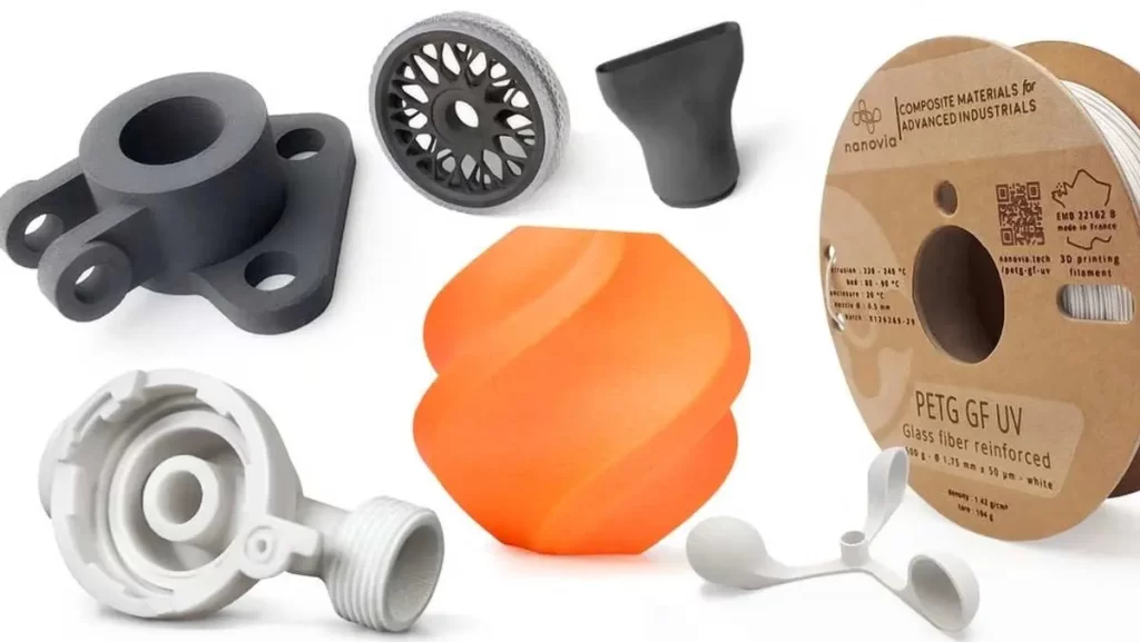 A variety of 3D printed objects and a spool of white 3D printer filament.