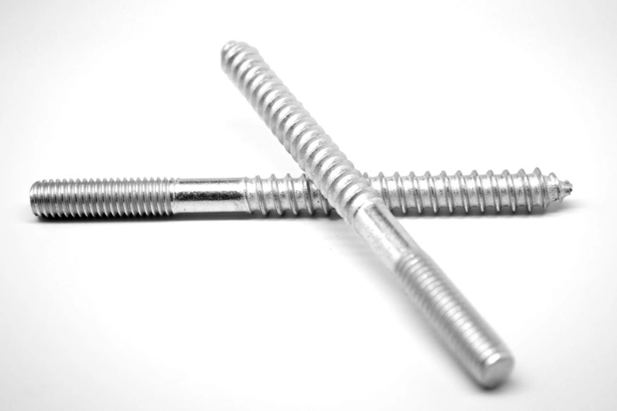 Two hanger bolts with one resting on top of the other