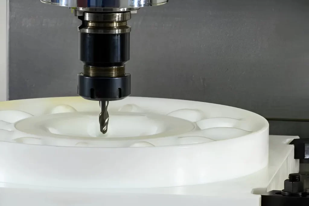 HDPE plastic part undergoing the CNC machining process.