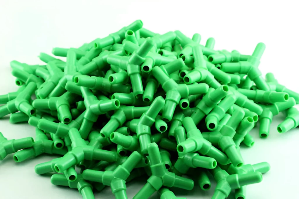 Bulk quantity of injection molded Y-connectors piled together.
