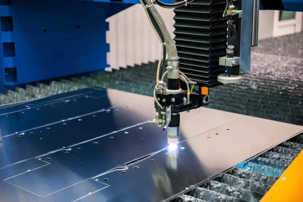 Image shows a laser cutting machine in operation on a sheet of metal.