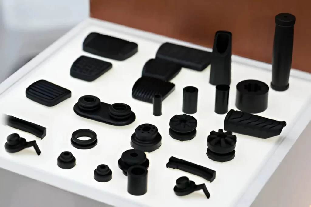 Machined plastic parts are displayed neatly on a white background.