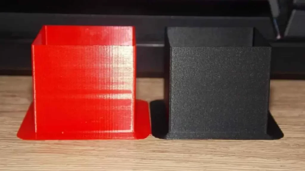 Matte finished ABS parts in black and red colors, showcasing uniform and sleek surface texture