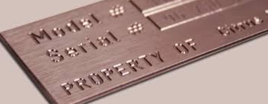 Image of text and symbols engraved on a metal plate