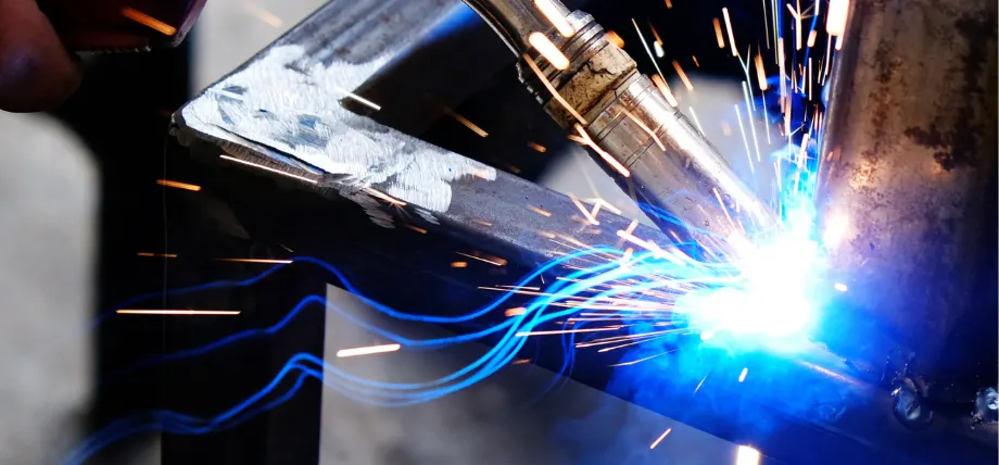 Welding on a metal corner with a blue spark