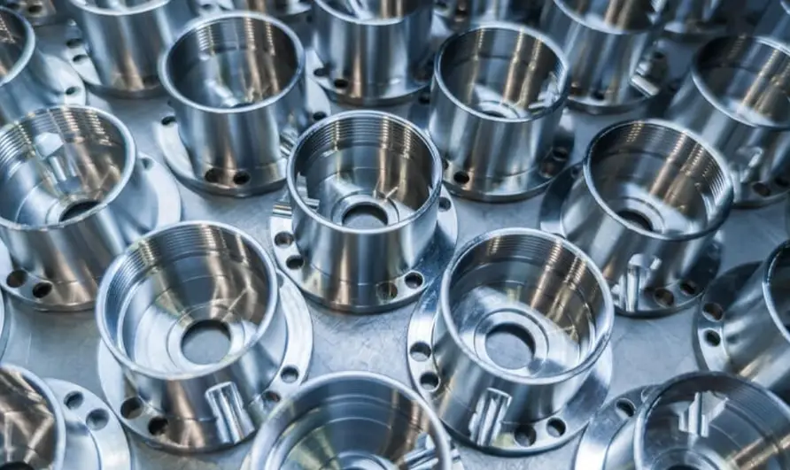 Multiple CNC-machined aluminum parts with threaded holes and precision flanges  