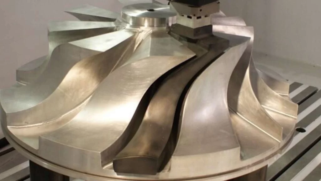 An image showing a turbine blade being carefully machined with EDM